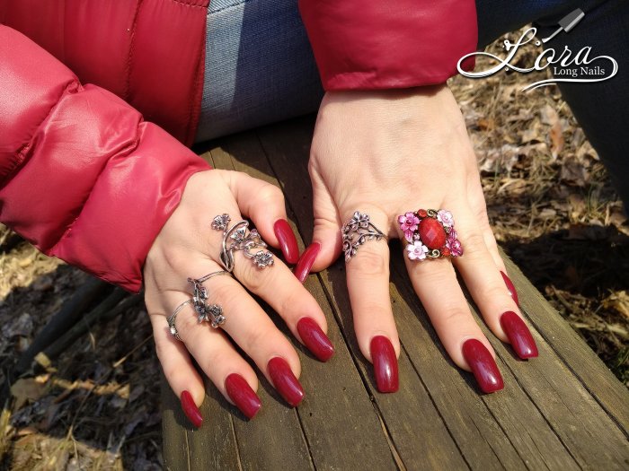 Red long nails on hands in the forest 🌲 photo shoot for video