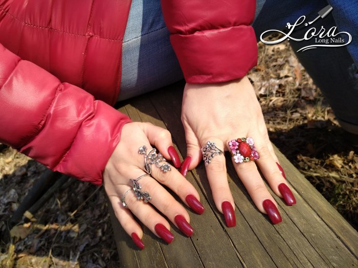 Red long nails on hands in the forest 🌲 photo shoot for video