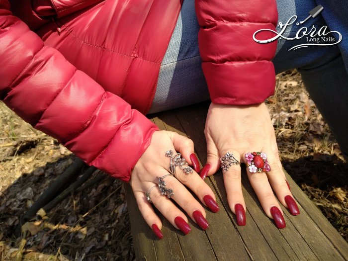 Red long nails on hands in the forest 🌲 photo shoot for video