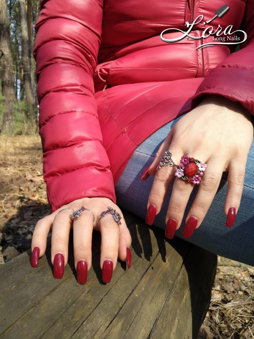 Red long nails on hands in the forest 🌲 photo shoot for video