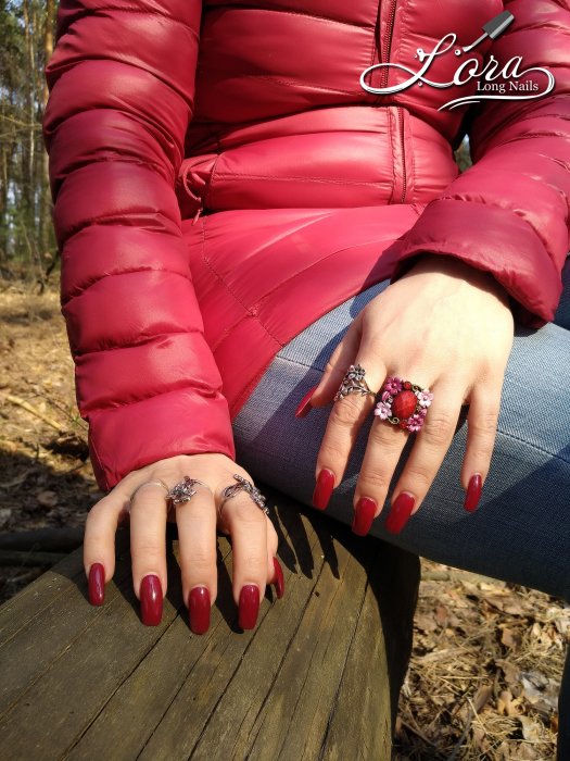 Red long nails on hands in the forest 🌲 photo shoot for video