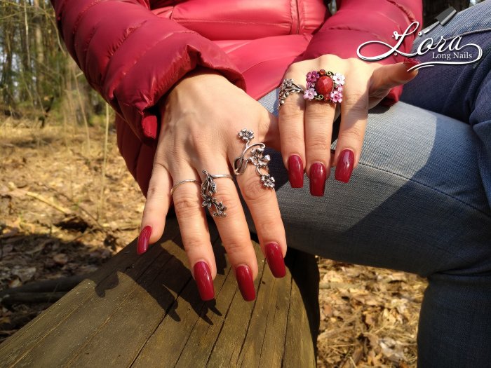 Red long nails on hands in the forest 🌲 photo shoot for video