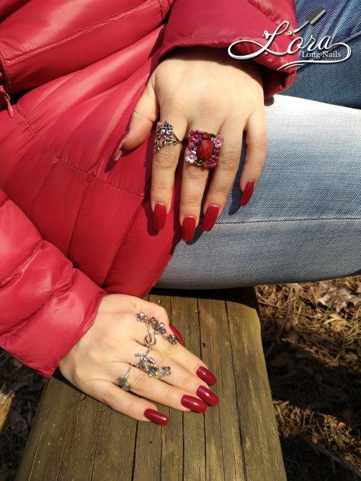 Red long nails on hands in the forest 🌲 photo shoot for video