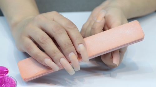 Photoshoot, doing a manicure. Long fingernails without polish